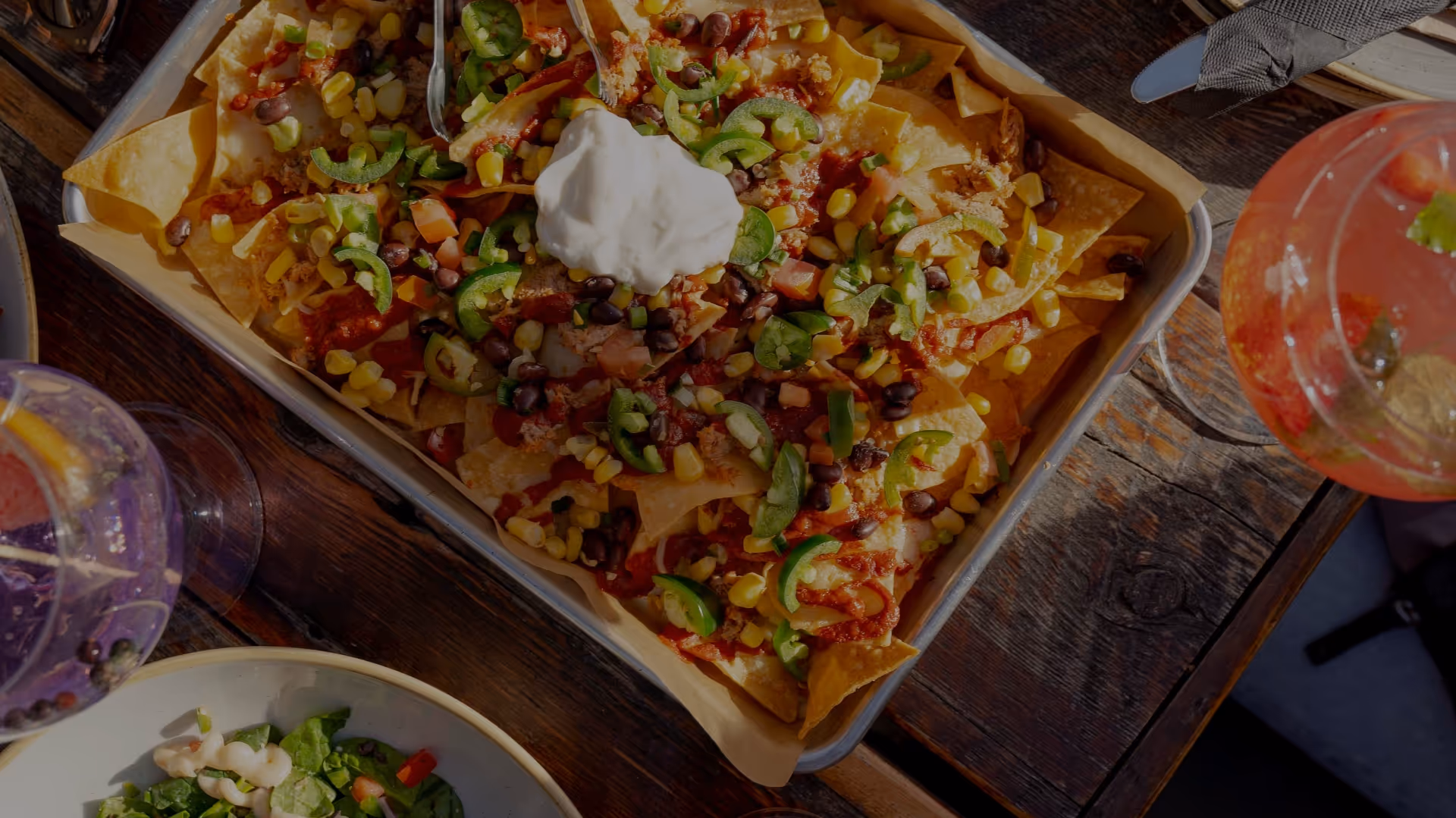 Craft nachos loaded with sour cream, jalapeños, corn and black beans at Madi's 12|12 in Inglewood, Calgary